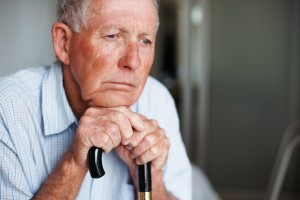 elderly man looking out window Orange County Elder Abuse Attorney