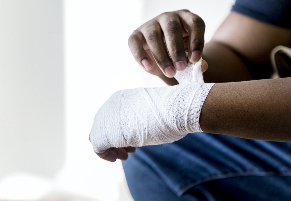Man Wrapping Injured Hand